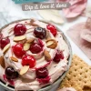 Cherry almond dip served in a bowl with graham crackers, garnished with whole cherries and almonds, with text overlay reading “Cherry Almond Dip – Dip it, love it, done.”