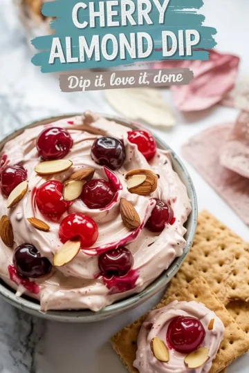 Cherry almond dip served in a bowl with graham crackers, garnished with whole cherries and almonds, with text overlay reading “Cherry Almond Dip – Dip it, love it, done.”