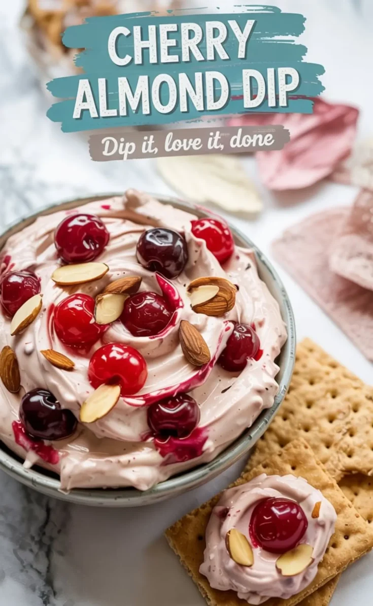 Cherry almond dip served in a bowl with graham crackers, garnished with whole cherries and almonds, with text overlay reading “Cherry Almond Dip – Dip it, love it, done.”