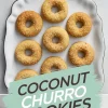 Overhead view of eight golden brown coconut churro cookies arranged neatly on a white scalloped-edge plate, with a bold text overlay reading “Coconut Churro Cookies” in black and white against a mint green brushstroke background.