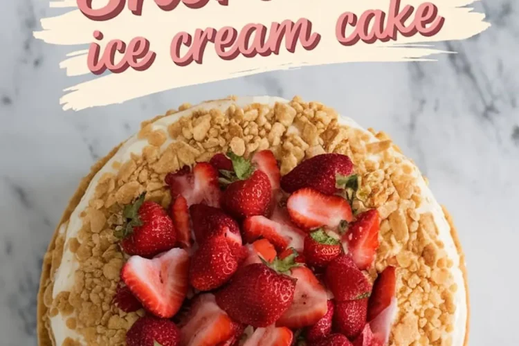 Overhead view of a strawberry shortcake ice cream cake topped with halved and whole fresh strawberries and golden cookie crumbles, set on a marble surface with bold text reading “Strawberry Shortcake ice cream cake.”