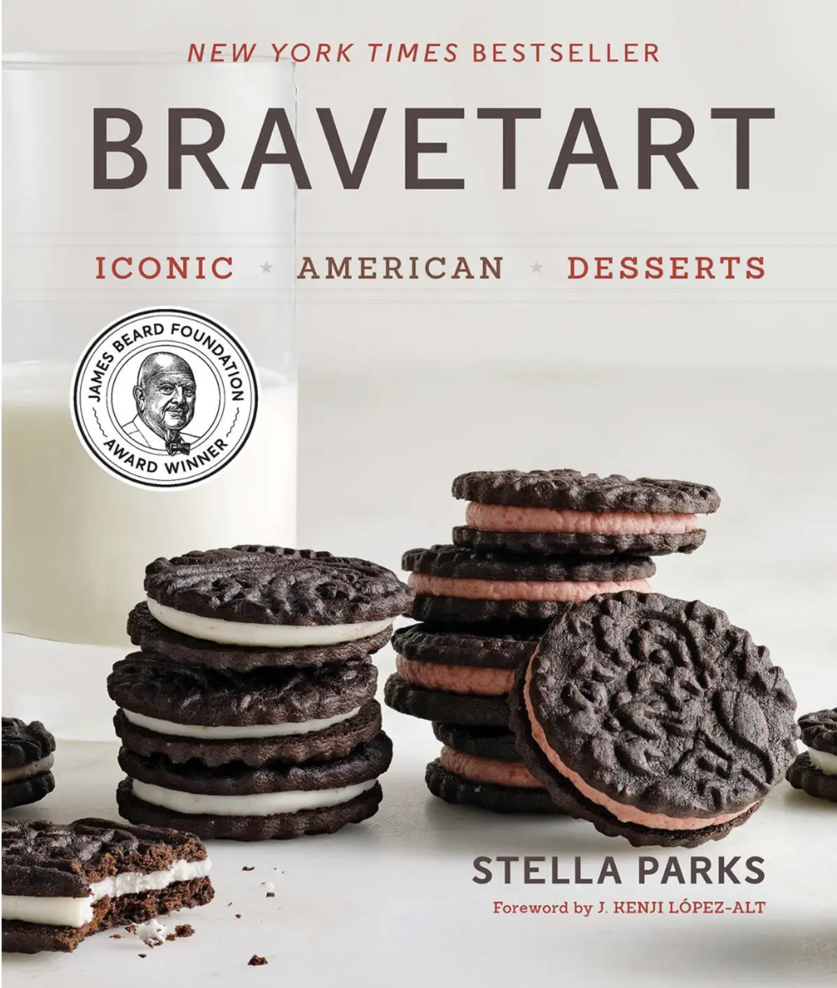 Cover of “Bravetart” by Stella Parks featuring a stack of homemade sandwich cookies with chocolate wafers and white or pink cream fillings, set beside a glass of milk and award medallion.