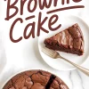 Flat lay of a sliced brownie cake on a white plate with a single wedge and fork on the side, placed on a marble background with “Brownie Cake” text in brown script.