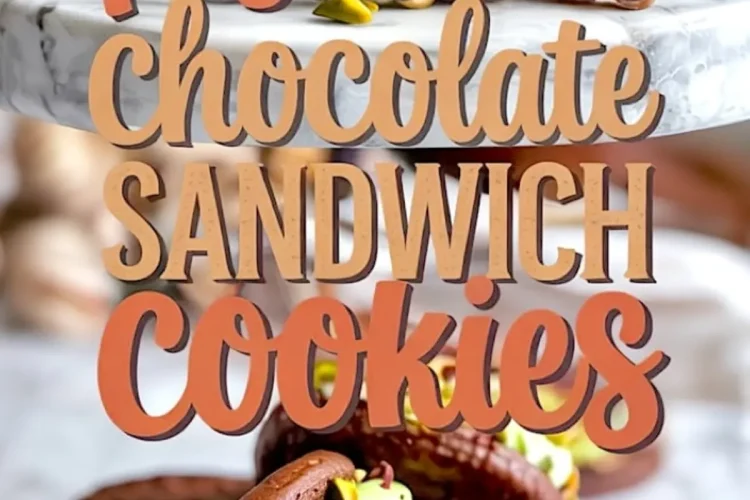 A close-up of chocolate pistachio sandwich cookies on a marble surface, filled with green pistachio cream and garnished with chopped pistachios, with decorative text overlaid.