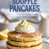 Stack of lemon soufflé pancakes topped with whipped cream and lemon zest, with large text reading “Lemon Soufflé Pancakes” in the background.