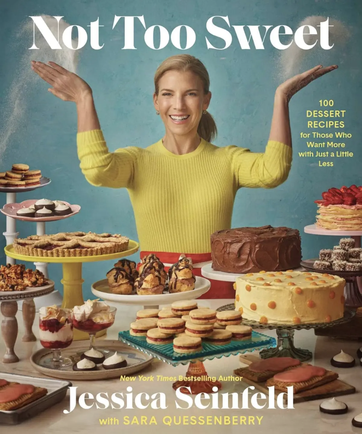 Cover of “Not Too Sweet” by Jessica Seinfeld showing the author in a yellow sweater surrounded by an abundant dessert spread, including layer cakes, cookies, cream puffs, and tarts on pastel cake stands.