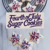 Collage featuring star-shaped sugar cookies with red, white, and blue sprinkle decorations arranged on a wire cooling rack and grouped on lollipop sticks in a glass jar with “Fourth of July Sugar Cookies” text in the center.
