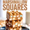 Three-layer stack of peanut butter marshmallow squares on a blue plate with text overlay, highlighting the smooth butterscotch base and colorful marshmallow chunks.