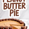 Peanut butter pie with chocolate cookie crust and mini peanut butter cups on top, with one slice pulled out, showing the rich, creamy peanut butter filling, text overlay “Peanut Butter Pie.”
