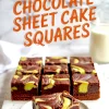 Neatly arranged squares of pistachio chocolate sheet cake feature bold swirls of vibrant green pistachio and dark chocolate layers with a dense, rich texture.
