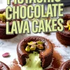 Rich chocolate lava cake filled with creamy pistachio center, topped with whole pistachios and dusted with cocoa powder, styled on a marble background.