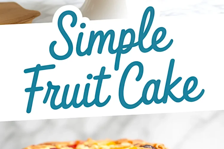 Simple fruit cake placed on a marble cake stand, with visible dried fruits like cherries, raisins, and apricots baked into the golden brown crust. An excellent example for fruit cake ideas, birthday fruit cake, and cake decorated with fruit.