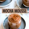 Mocha mousse in glass cups on dark saucers, swirled with piped peaks and dusted with cocoa powder, featuring a text overlay “Mocha Mousse” in bold black font.