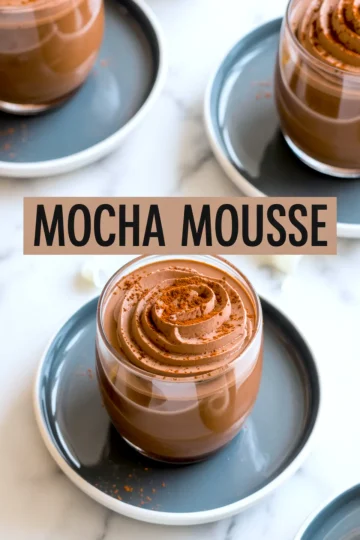 Mocha mousse in glass cups on dark saucers, swirled with piped peaks and dusted with cocoa powder, featuring a text overlay “Mocha Mousse” in bold black font.