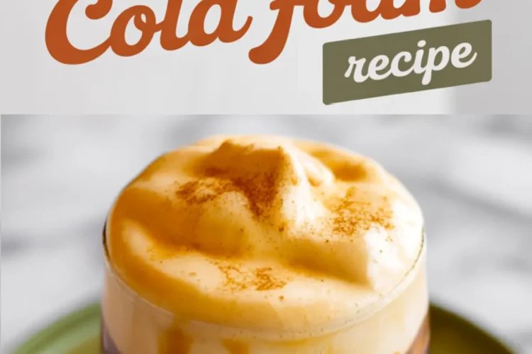 A glass of cold brew topped with thick pumpkin cream cold foam, garnished with a sprinkle of cinnamon, placed on a green ceramic plate with “Pumpkin Cream Cold Foam recipe” text above.