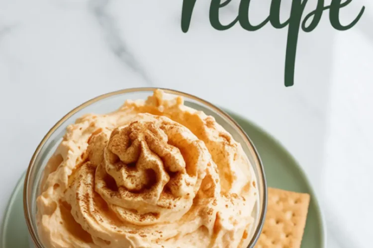 Overhead view of whipped pumpkin fluff served in a glass dish with a cinnamon sprinkle, styled with square graham crackers on a green plate and “pumpkin fluff recipe” text above on a marble background.
