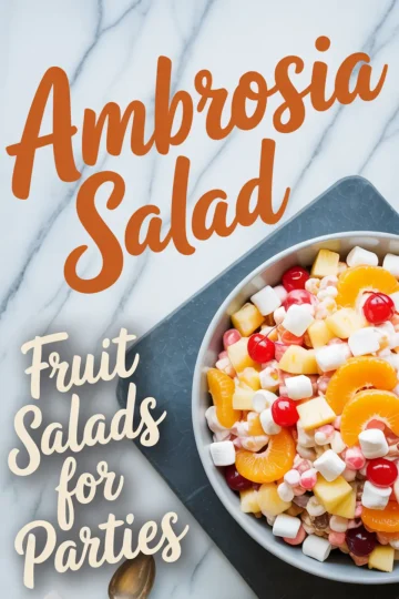 Flat lay of a serving bowl filled with ambrosia salad placed on a gray plate over a marble surface, surrounded by mini marshmallows and featuring text “Ambrosia Salad – Fruit Salads for Parties.”