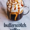 A clear glass mug of butterscotch coffee with swirled whipped cream, thick caramel drizzle, and light brown sugar chunks on a white marble background with “butterscotch coffee” text overlay.