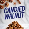 Top view of glazed walnuts scattered with cinnamon sticks and spice powder, and a lower view showing a bowl of candied walnuts with large text reading “Candied Walnut.”