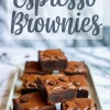Tray of rich espresso brownies topped with cocoa powder and coffee beans. Text overlay reads “Espresso Brownies.”
