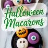 Halloween-themed macarons in ghost, pumpkin, and monster eye designs displayed in white and black dishes with text overlay reading “Halloween Macarons.”