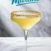 Single lemon drop martini in a margarita glass with gold sugar rim and pale yellow cocktail, set against a marble backdrop with “Lemon Drop Martini” text overlay.