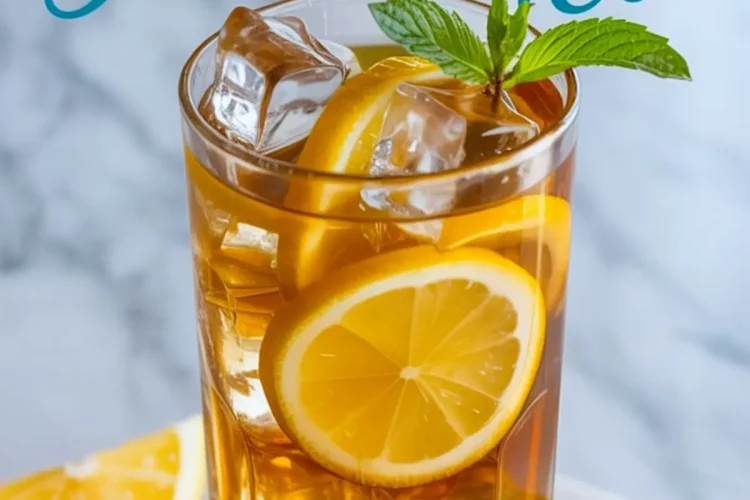 Close-up of iced lemon tea in a tall glass with lemon slices, ice cubes, and mint garnish, with “Lemon tea” text in cursive above on a bright marble tabletop.