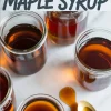 Collage with multiple glass jars filled with golden brown maple syrup and a gold spoon with spilled syrup, overlaid with bold text reading “Homemade Maple Syrup.”