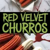 Overhead view of red velvet churros with sugar coating and white chocolate-dipped ends, served on a small parchment-lined tray. The marble surface is decorated with artistic red splatters, adding visual flair to the dessert presentation.