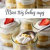Glass jars filled with mini tres leches cake layered with whipped cream and sponge cake, topped with fresh strawberry halves, displayed on a marble surface in a collage showing a spoonful of the dessert being served.