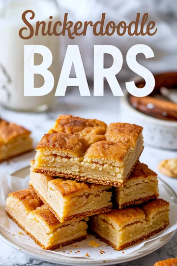 Alt text: Stack of golden snickerdoodle bars on a plate with visible cinnamon crust and soft, chewy center, styled with text reading “Snickerdoodle Bars” in bold lettering.