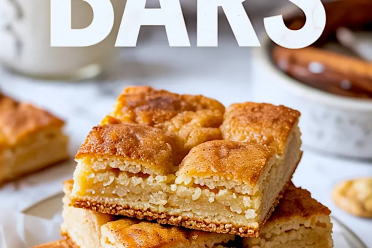 Alt text: Stack of golden snickerdoodle bars on a plate with visible cinnamon crust and soft, chewy center, styled with text reading “Snickerdoodle Bars” in bold lettering.