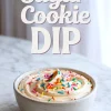 Bowl of sugar cookie dip topped with colorful rainbow sprinkles, placed on a marble counter with soft natural lighting and bold title text above.