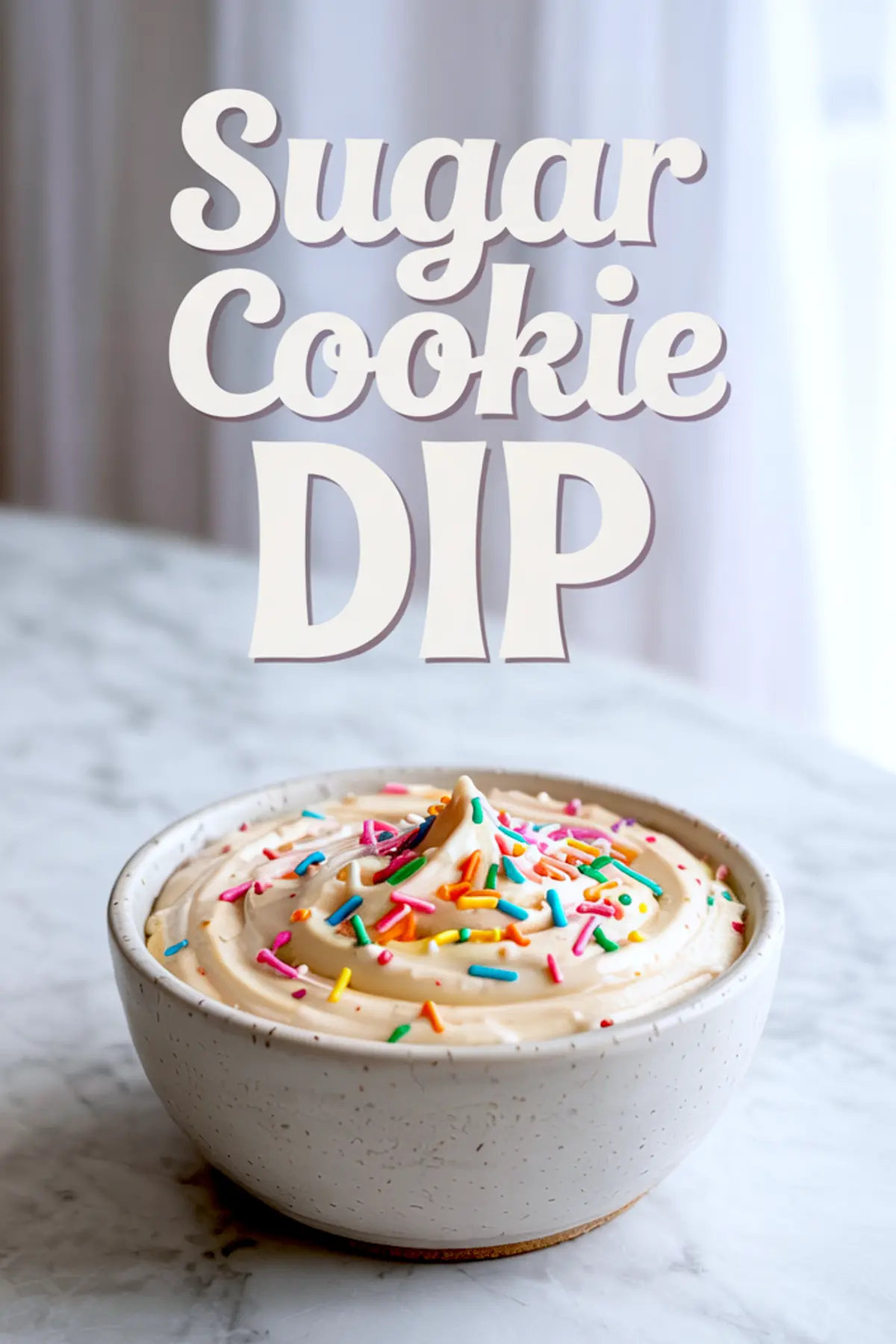 Bowl of sugar cookie dip topped with colorful rainbow sprinkles, placed on a marble counter with soft natural lighting and bold title text above.
