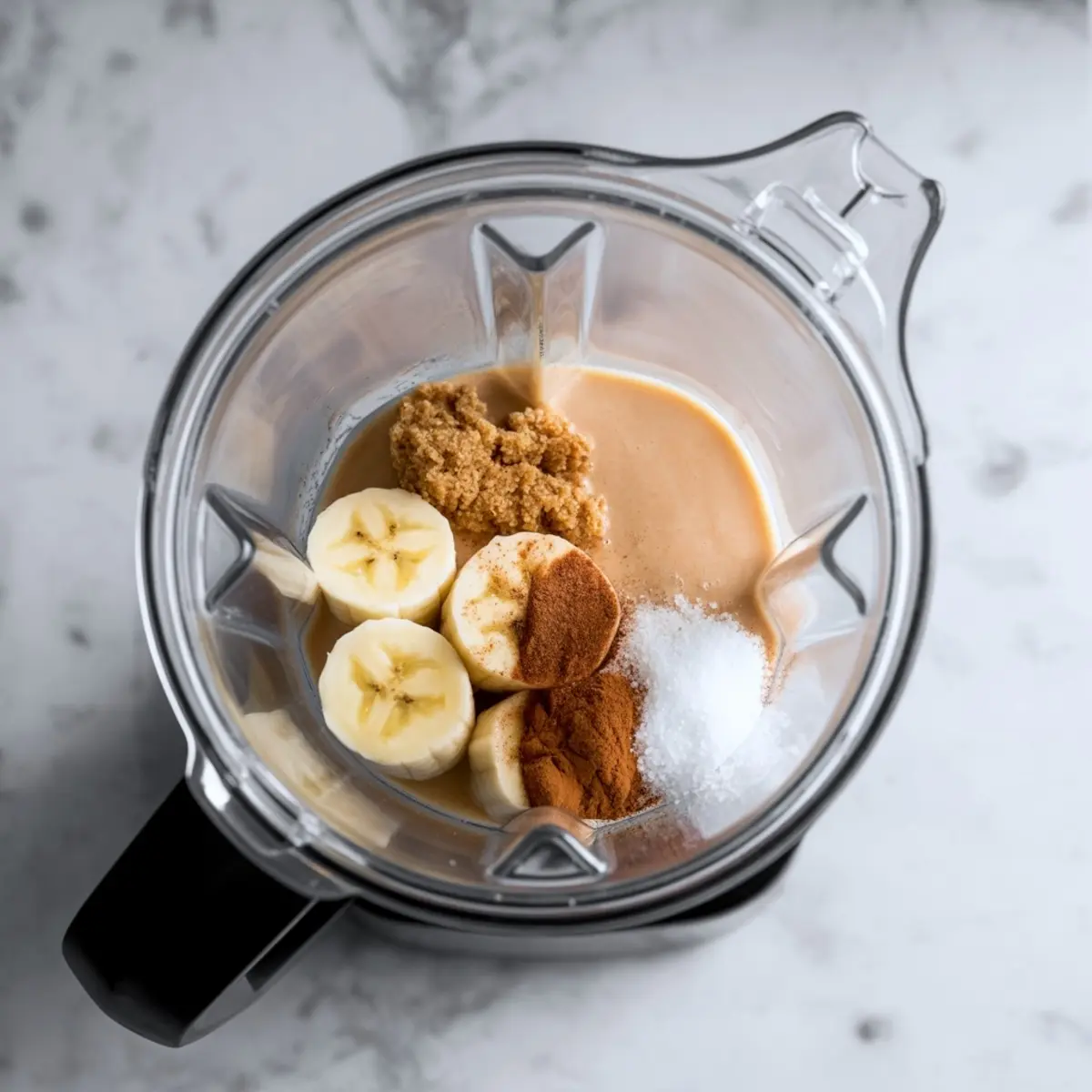 Two cinnamon roll smoothie bowls topped with white yogurt swirl and crushed cinnamon cereal, shown in a vertical collage with bold text overlay reading “Cinnamon Roll Smoothie Bowl,” styled on a white marble background with cinnamon sticks.