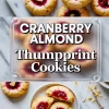 Two-image collage of cranberry almond thumbprint cookies, with the top showing golden cookies filled with vibrant cranberry jam on a marble background, and the bottom showcasing a broken cookie revealing a soft interior and glossy filling, styled with almond slices and crumbs.