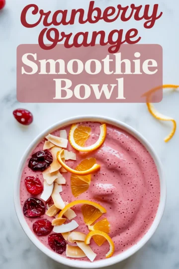 Cranberry orange smoothie bowl topped with dried cranberries, toasted coconut flakes, and fresh orange slices, styled on a white marble background with text overlay promoting the smoothie bowl.