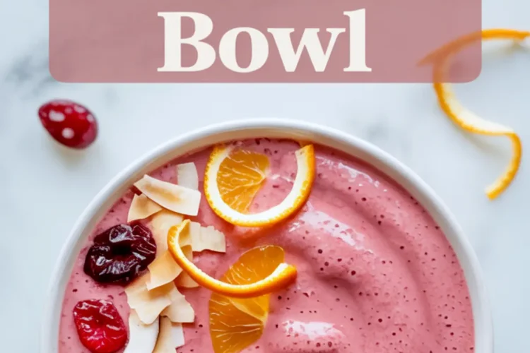 Cranberry orange smoothie bowl topped with dried cranberries, toasted coconut flakes, and fresh orange slices, styled on a white marble background with text overlay promoting the smoothie bowl.