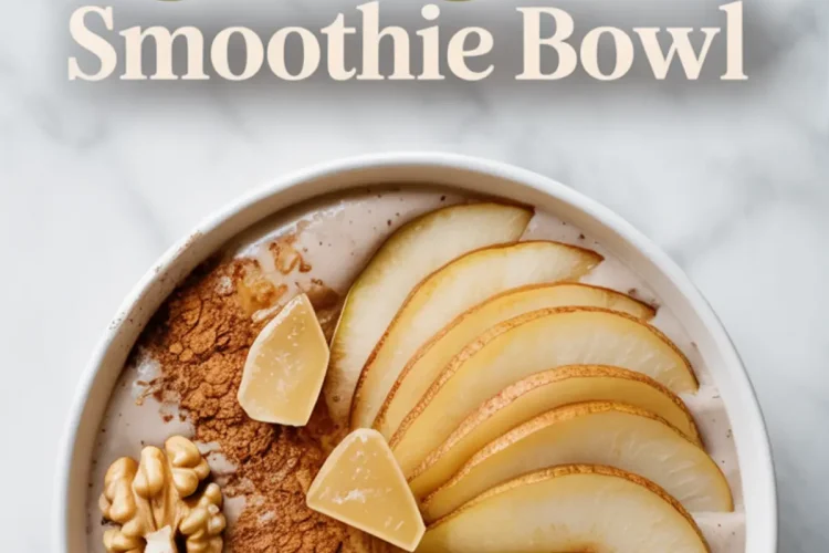 Overhead view of a pear ginger smoothie bowl topped with thin pear slices, chopped candied ginger, walnuts, and ground cinnamon, placed on a light marble surface with text above reading “Pear Ginger Smoothie Bowl.”
