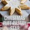 Christmas puff pastry star dessert displayed on a marble plate with powdered sugar dusting. The golden, flaky layers are shaped into a star, with a holiday-themed overlay text that reads “CHRISTMAS PUFF PASTRY STAR” for seasonal baking inspiration.