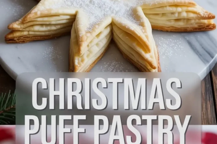 Christmas puff pastry star dessert displayed on a marble plate with powdered sugar dusting. The golden, flaky layers are shaped into a star, with a holiday-themed overlay text that reads “CHRISTMAS PUFF PASTRY STAR” for seasonal baking inspiration.