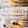 Vertical collage featuring almond flour pancakes with berries on top and a sliced pancake stack below with text reading almond flour pancakes low carb pancakes.