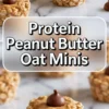 Close-up of protein peanut butter oat minis on a marble surface, with centered bold text reading “Protein Peanut Butter Oat Minis” for recipe promotion.