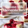 Square coconut milk cheesecake bars with a golden graham cracker crust and vibrant cherry swirl topping, displayed on white plates and a cooling rack, styled with a clean and minimal marble background.