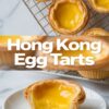 Golden Hong Kong egg tarts with glossy custard centers on a cooling rack, paired with a close-up of a bitten tart revealing creamy egg filling and flaky puff pastry crust, placed on a white plate.