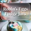 Robin’s Eggs fudge jars collage shows pastel blue and yellow layered white chocolate fudge in small glass jars topped with pink and blue speckled candy eggs. Text overlay reads Robin’s Eggs Fudge Jars above a spoon lifting a thick, creamy fudge bite with a candy egg center. Easter dessert jars sit on a white marble countertop with scattered chocolate eggs for a festive spring treat presentation.