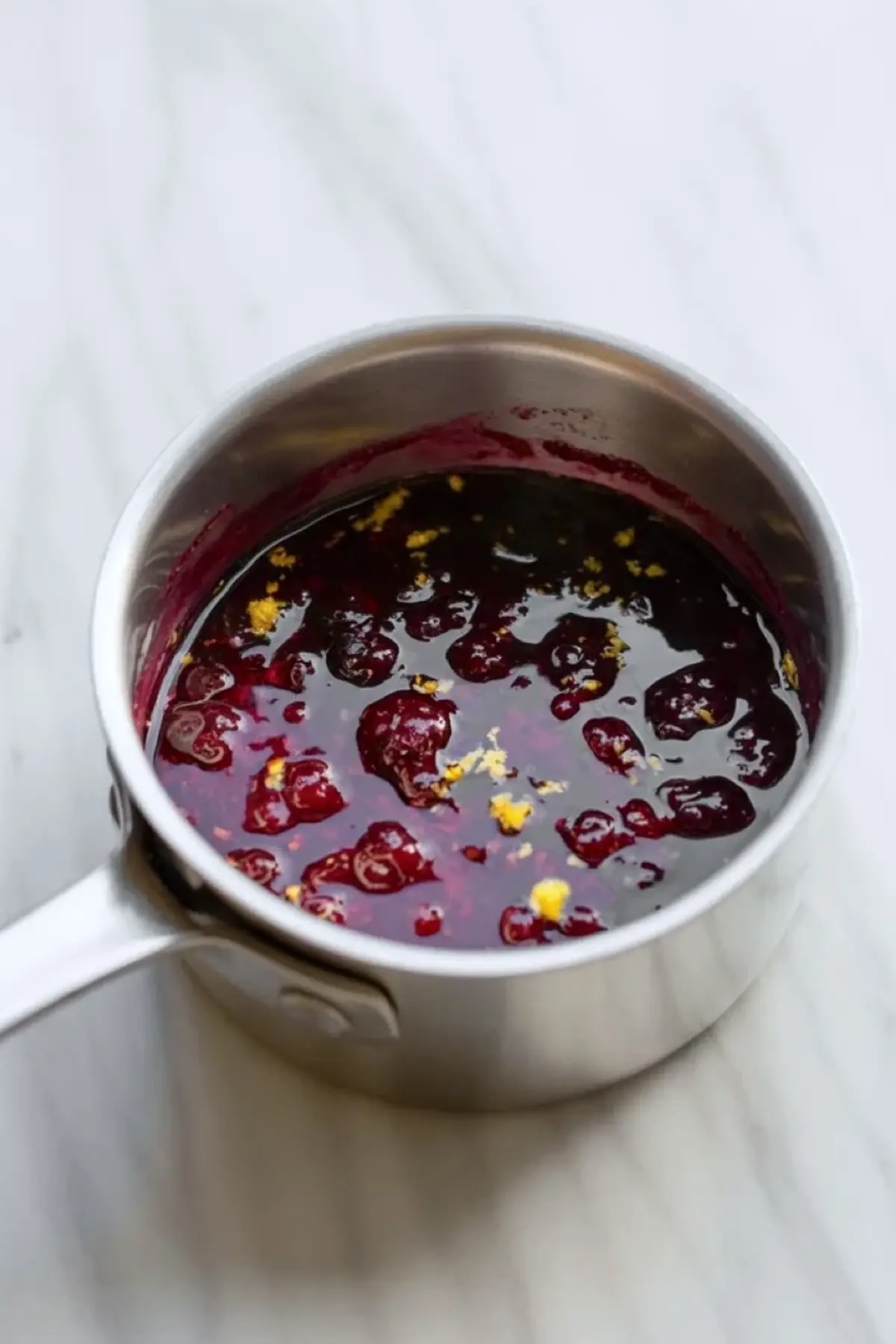 Mulberry lemon filling cooking in a saucepan for lemon mulberry crumble bars.