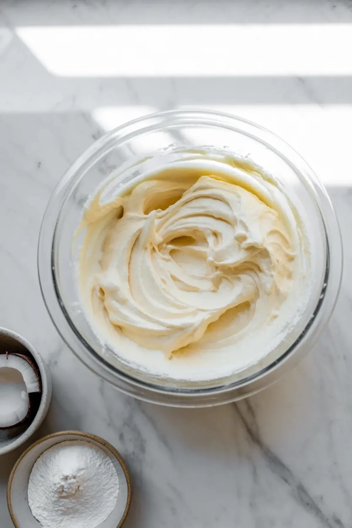 Ingredients for mango coconut key lime bars arranged in bowls, including mango, lime, coconut, crust crumbs, and creamy filling ingredients.