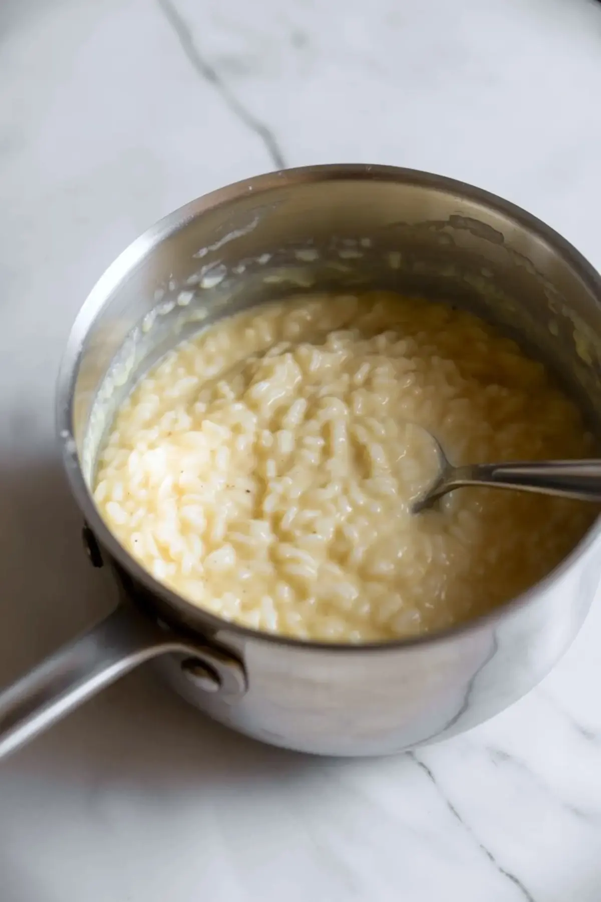 Rice pudding cooks in a saucepan until thick and creamy for vanilla poached pear rice pudding.