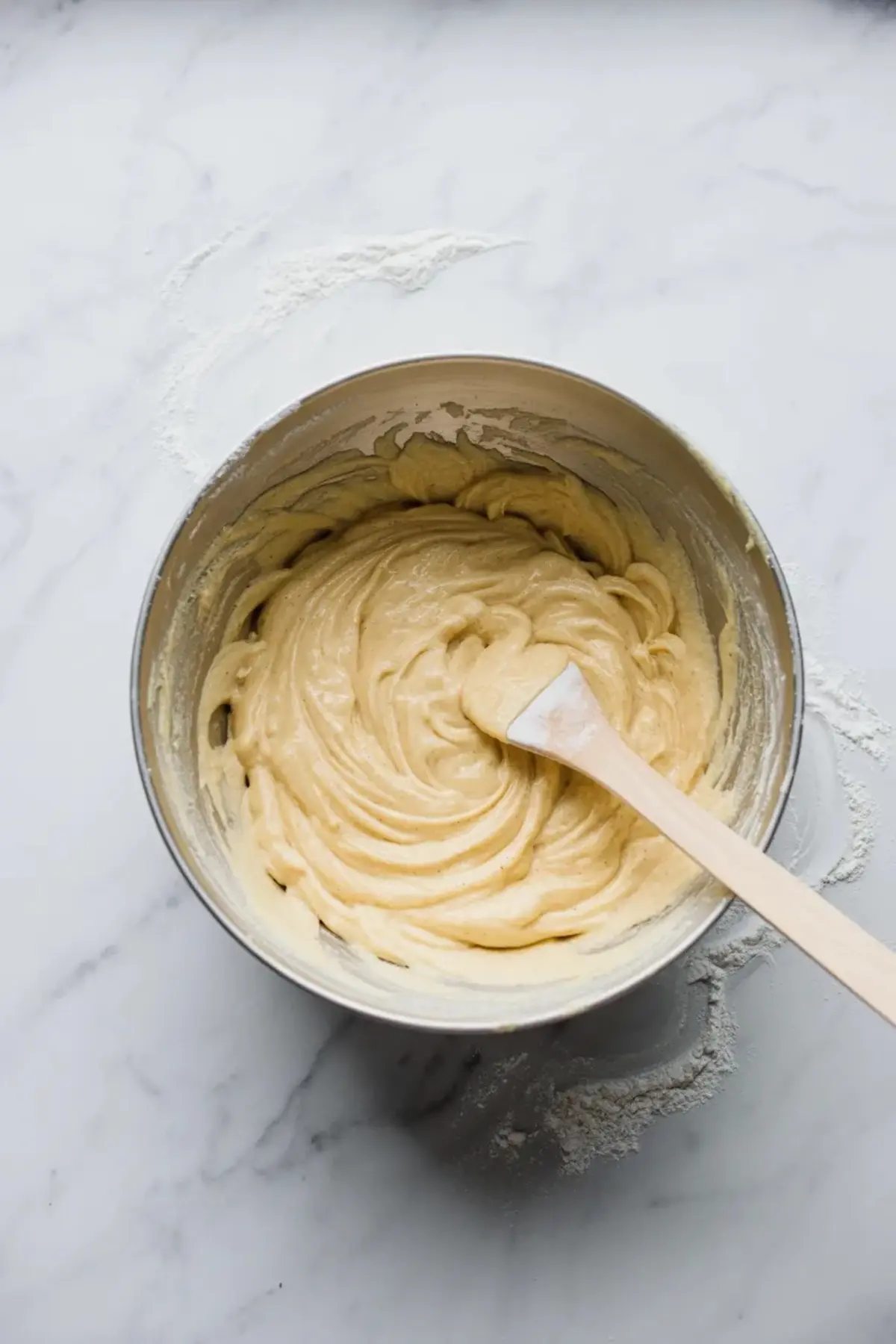 Blueberry cobbler filling in a bowl before baking, showing the berries coated and ready for the dish.